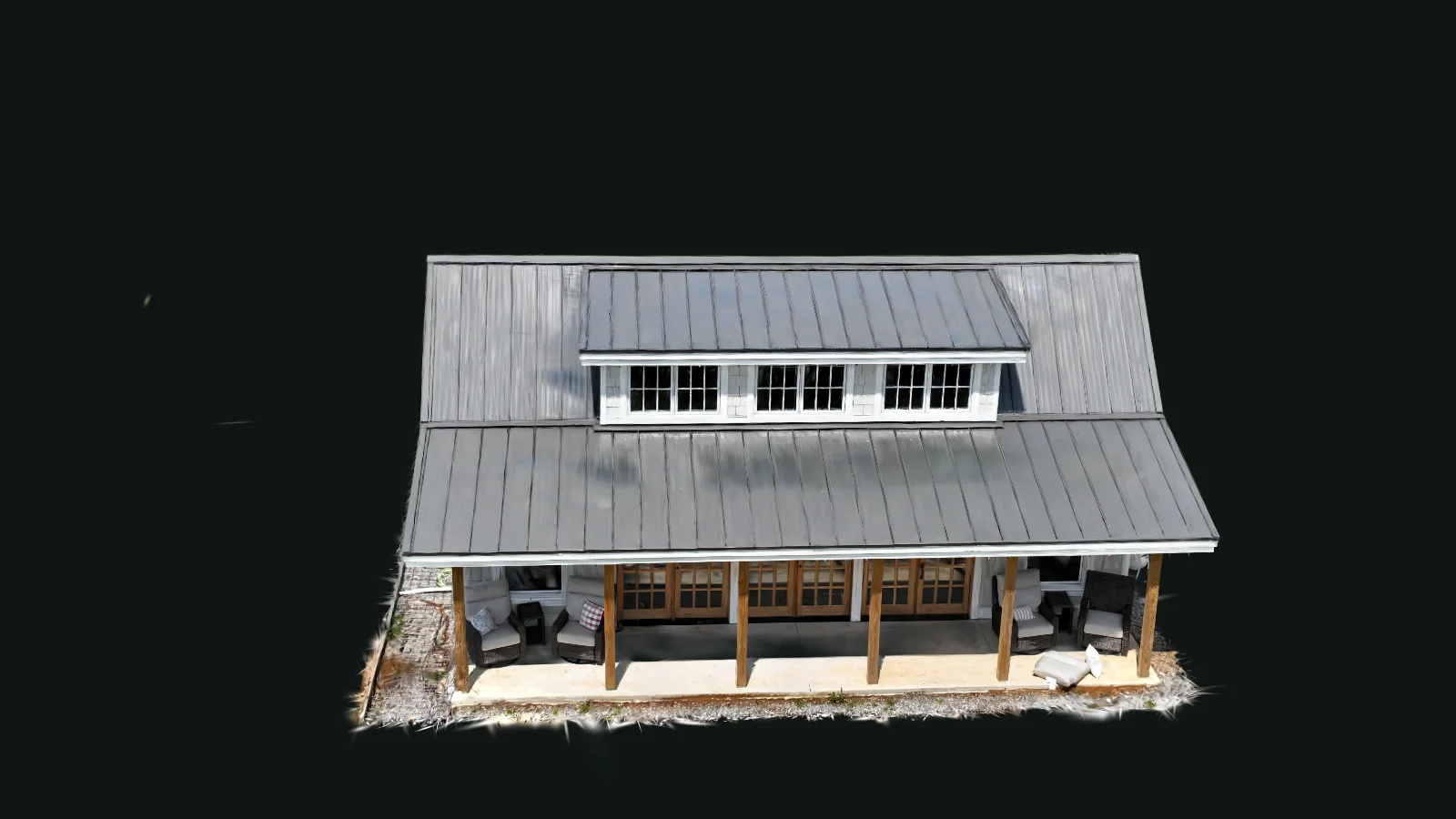 A photorealistic 3D reconstruction of a pool house — metal roof, dormer windows, and a covered porch — captured by drone.